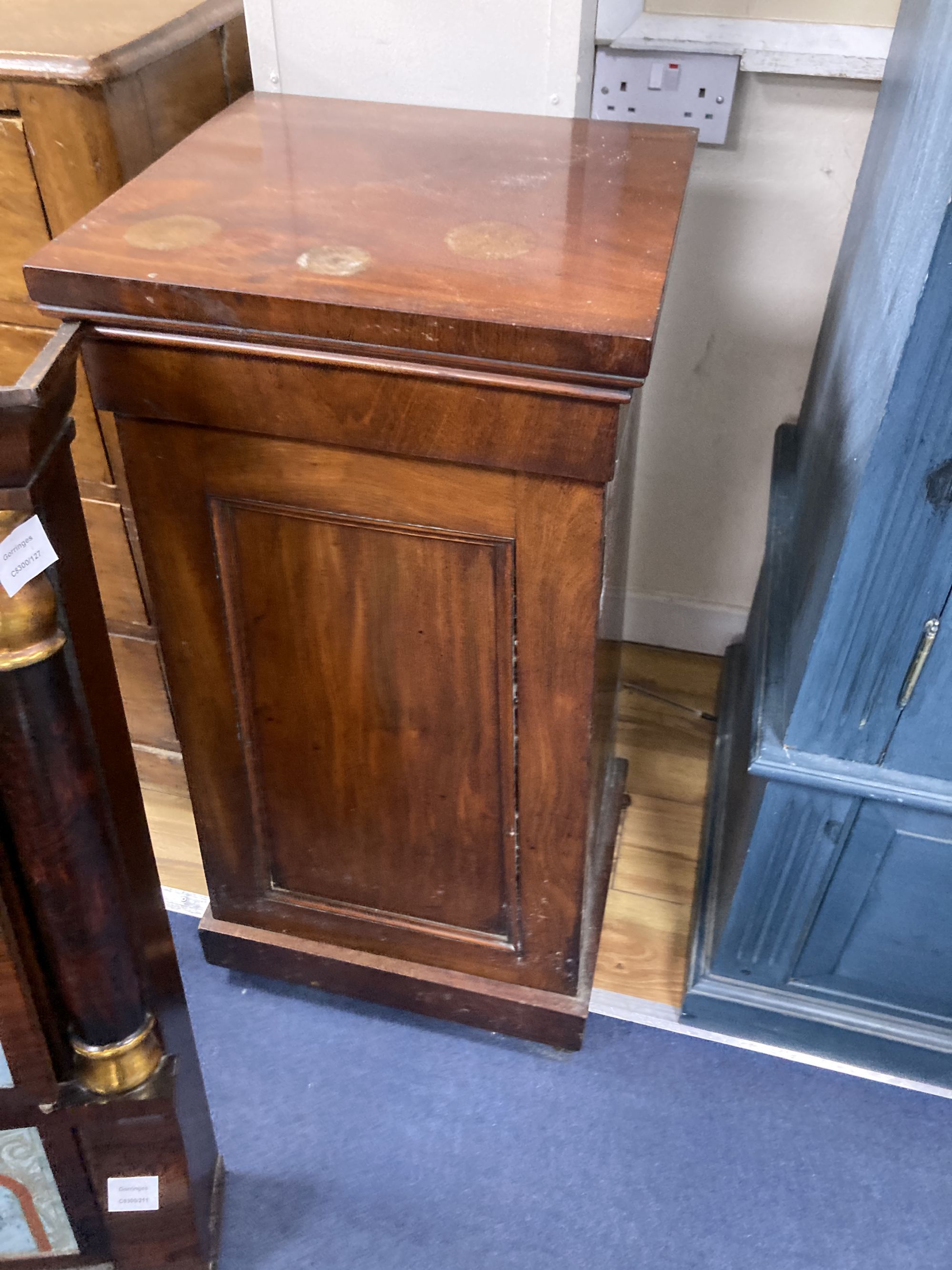 A 19th century American simulated rosewood wall clock, height 84cm, a 19th century inlaid wall clock and a mahogany pedestal cupboard